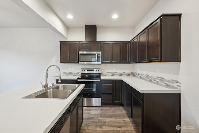 kitchen with sink, decorative backsplash, dark hardwood / wood-style flooring, appliances with stainless steel finishes, and dark brown cabinetry