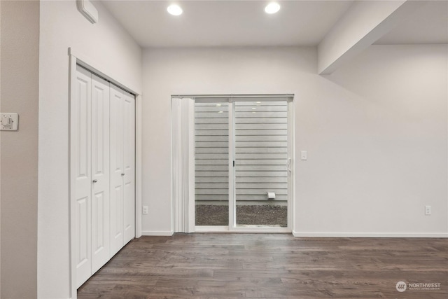 unfurnished bedroom featuring dark hardwood / wood-style floors