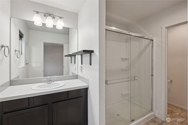 bathroom with an enclosed shower and vanity