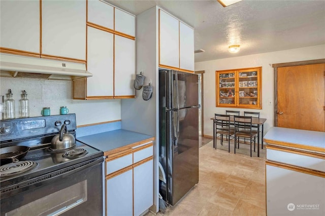 kitchen with black appliances, white cabinets, and a textured ceiling