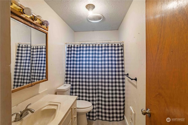 bathroom with a textured ceiling, toilet, and vanity