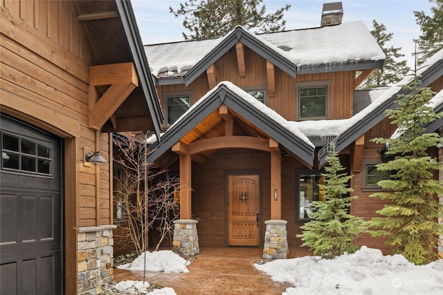 view of snow covered property entrance