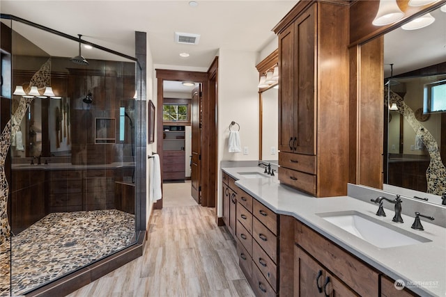 bathroom featuring vanity, hardwood / wood-style flooring, and a shower with shower door