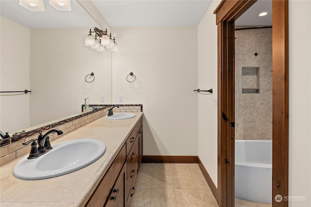 bathroom featuring decorative backsplash, tile patterned flooring, and vanity