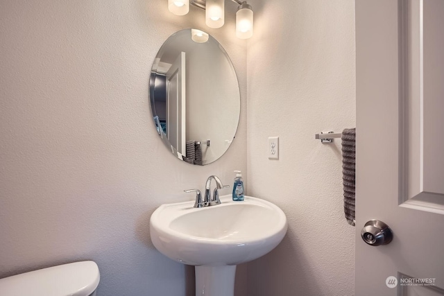 bathroom featuring sink and toilet