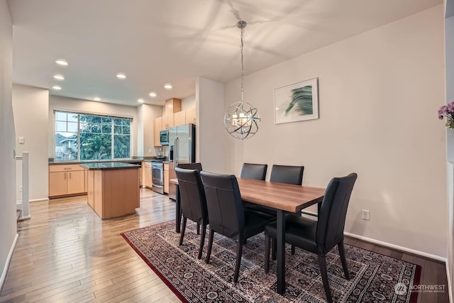 dining room featuring light hardwood / wood-style floors and a chandelier