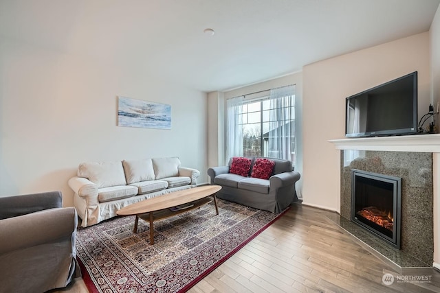 living room featuring hardwood / wood-style flooring and a premium fireplace