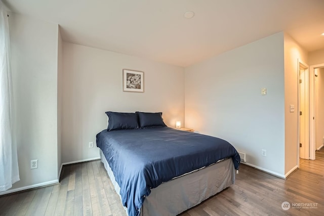 bedroom with hardwood / wood-style flooring