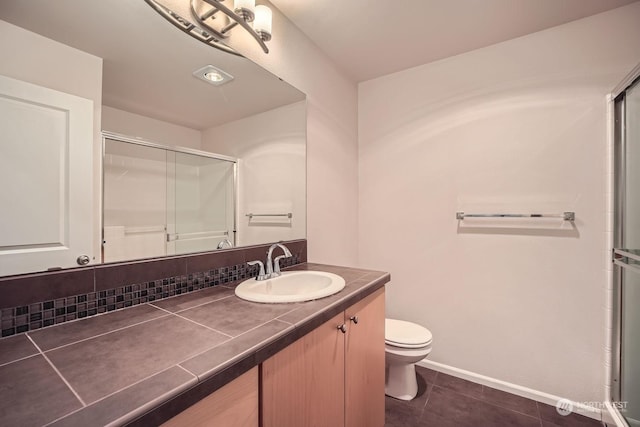 bathroom featuring an enclosed shower, vanity, decorative backsplash, and toilet