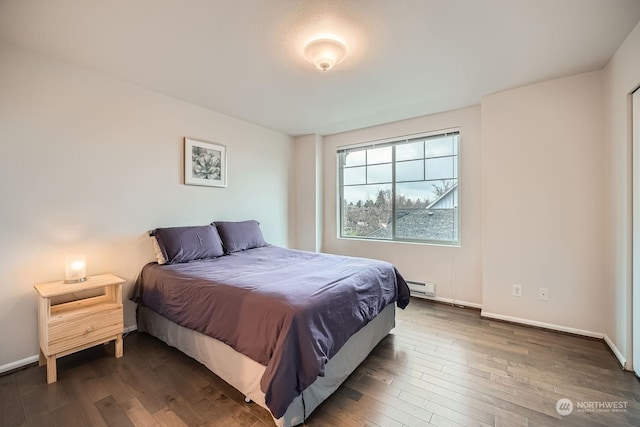 bedroom featuring dark wood-type flooring and baseboard heating