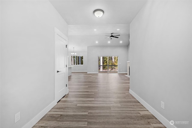 hall featuring a chandelier and light hardwood / wood-style flooring