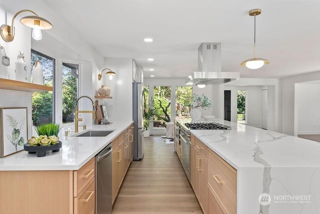 kitchen featuring sink, light brown cabinets, stainless steel appliances, hanging light fixtures, and island range hood