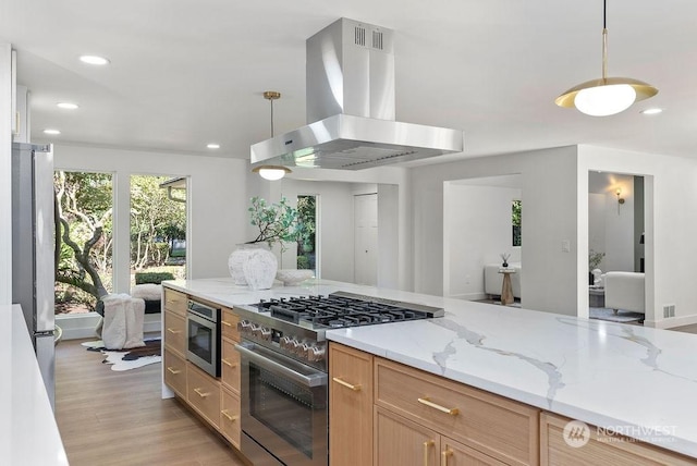 kitchen featuring light stone countertops, light brown cabinets, stainless steel appliances, ventilation hood, and decorative light fixtures