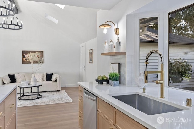 kitchen with sink, pendant lighting, light brown cabinets, hardwood / wood-style flooring, and dishwasher