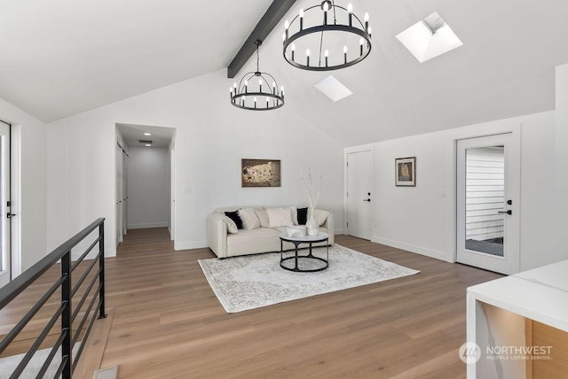 living room with high vaulted ceiling, a skylight, hardwood / wood-style flooring, beamed ceiling, and a notable chandelier