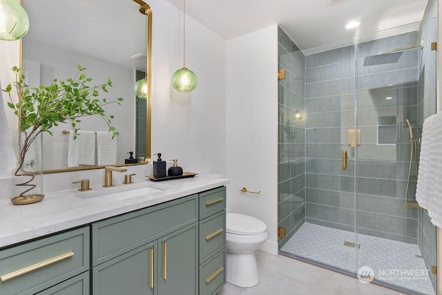 bathroom featuring tile patterned flooring, vanity, toilet, and an enclosed shower