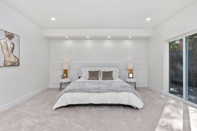 bedroom featuring light colored carpet and access to outside