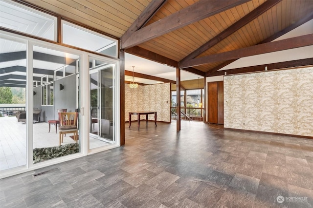 interior space with wooden ceiling, a healthy amount of sunlight, and lofted ceiling with beams