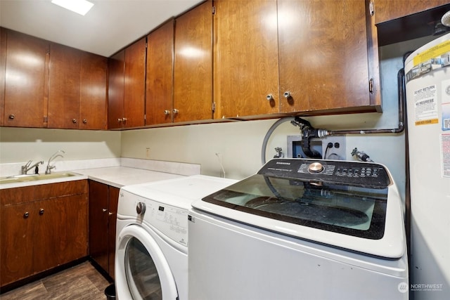 washroom with cabinets, independent washer and dryer, and sink