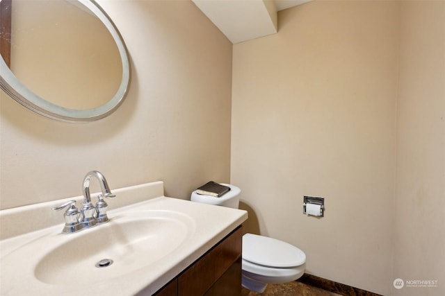 bathroom featuring toilet and vanity