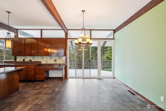 kitchen featuring tasteful backsplash, beamed ceiling, hanging light fixtures, and a chandelier