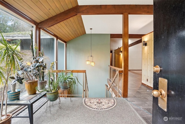 interior space with wood ceiling and lofted ceiling with beams