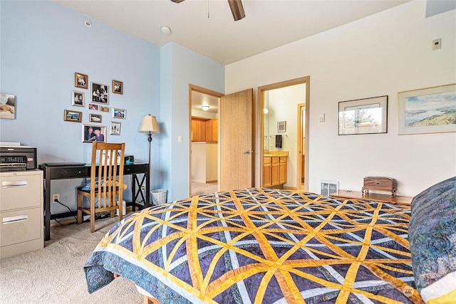 bedroom with light colored carpet, ceiling fan, and ensuite bathroom