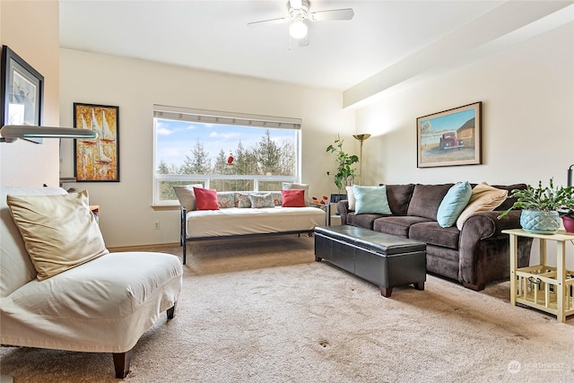 carpeted living room with ceiling fan