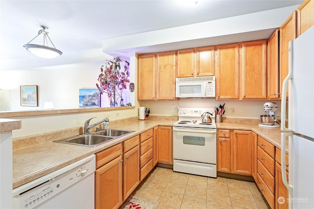 kitchen with decorative light fixtures, white appliances, sink, and light tile patterned floors