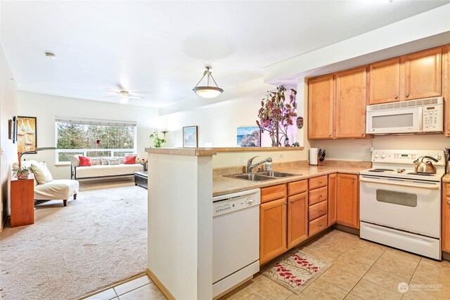 kitchen featuring ceiling fan, sink, kitchen peninsula, white appliances, and light carpet