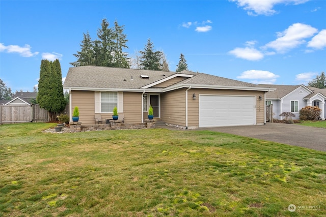 ranch-style house featuring a front yard and a garage