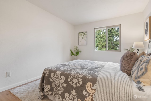 bedroom with hardwood / wood-style floors