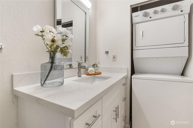 bathroom with vanity and stacked washing maching and dryer