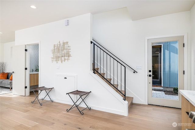 stairs with hardwood / wood-style flooring