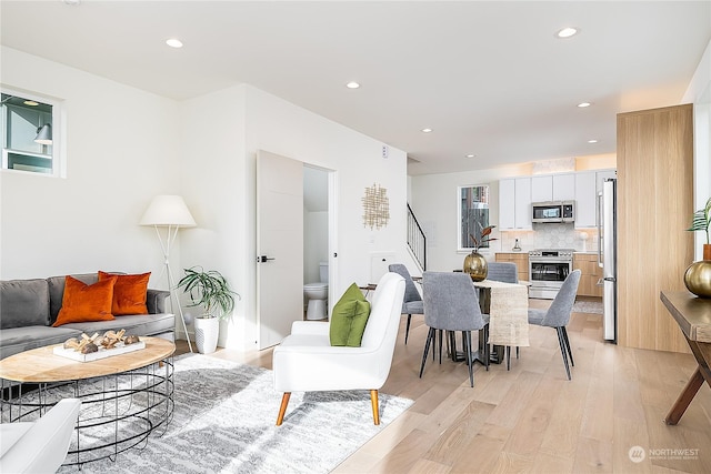 living room with a wealth of natural light and light wood-type flooring