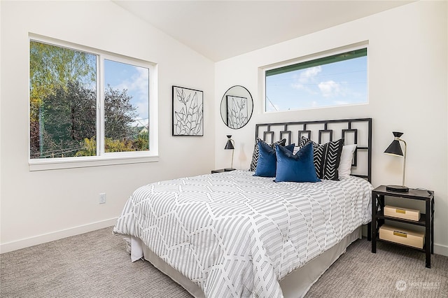 carpeted bedroom featuring lofted ceiling