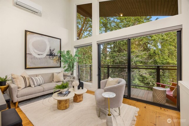 sunroom with vaulted ceiling and a wall unit AC