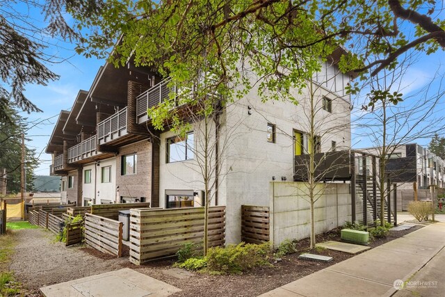 view of side of home featuring a balcony