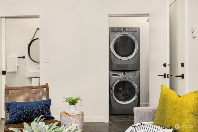 laundry area featuring stacked washer and clothes dryer