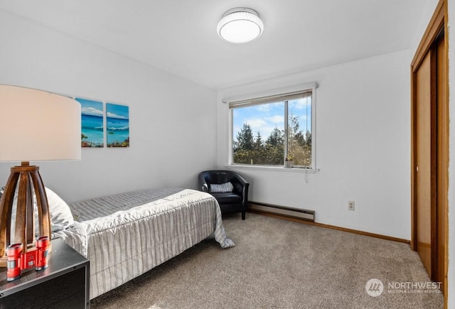 bedroom with a closet, carpet floors, and a baseboard heating unit