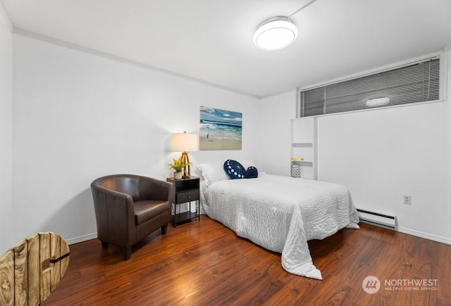 bedroom with baseboard heating and wood-type flooring