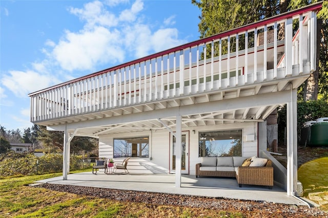 rear view of house featuring a balcony, a patio, and an outdoor hangout area