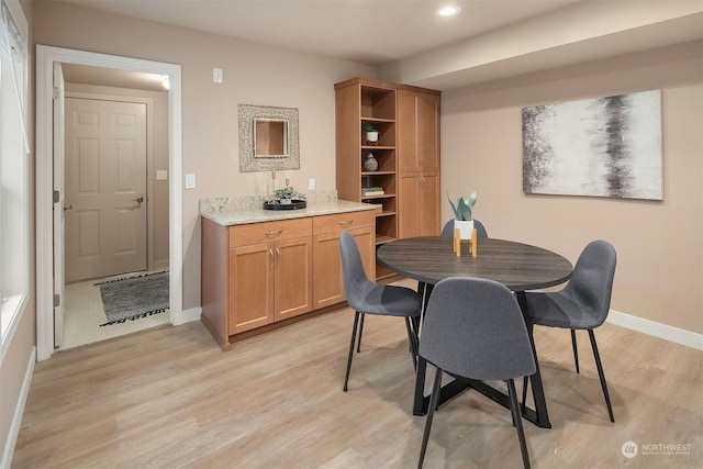 dining space featuring light wood-type flooring