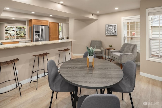 dining space with light hardwood / wood-style flooring