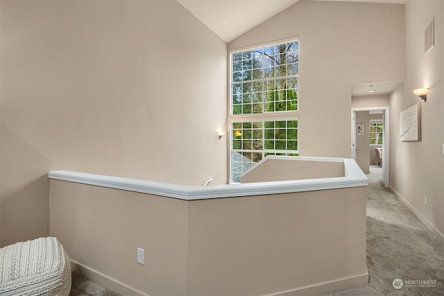 interior space featuring light carpet and lofted ceiling