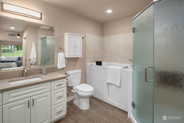 bathroom featuring ceiling fan, toilet, a shower with shower door, and vanity