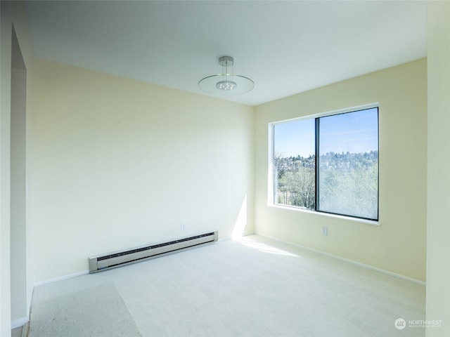 carpeted empty room with baseboard heating