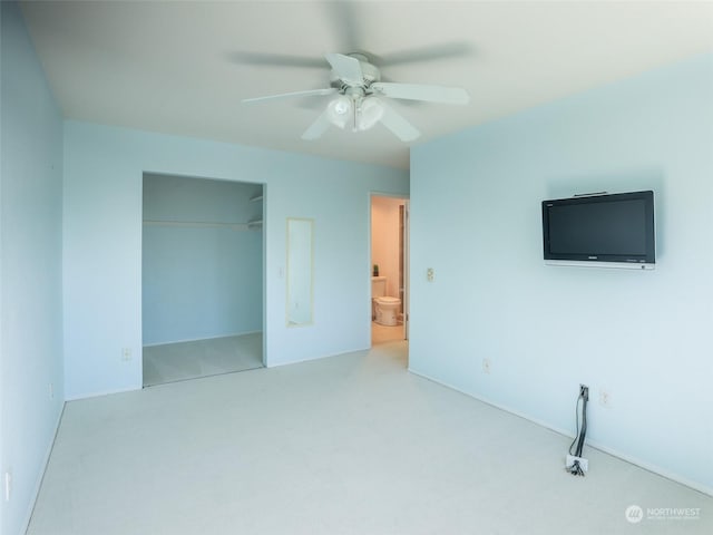 unfurnished bedroom with connected bathroom, ceiling fan, a closet, and light colored carpet