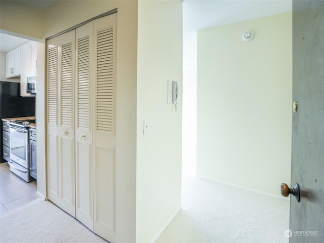 corridor featuring light colored carpet