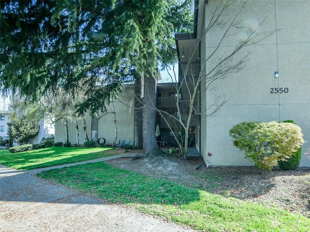 view of side of home with a yard